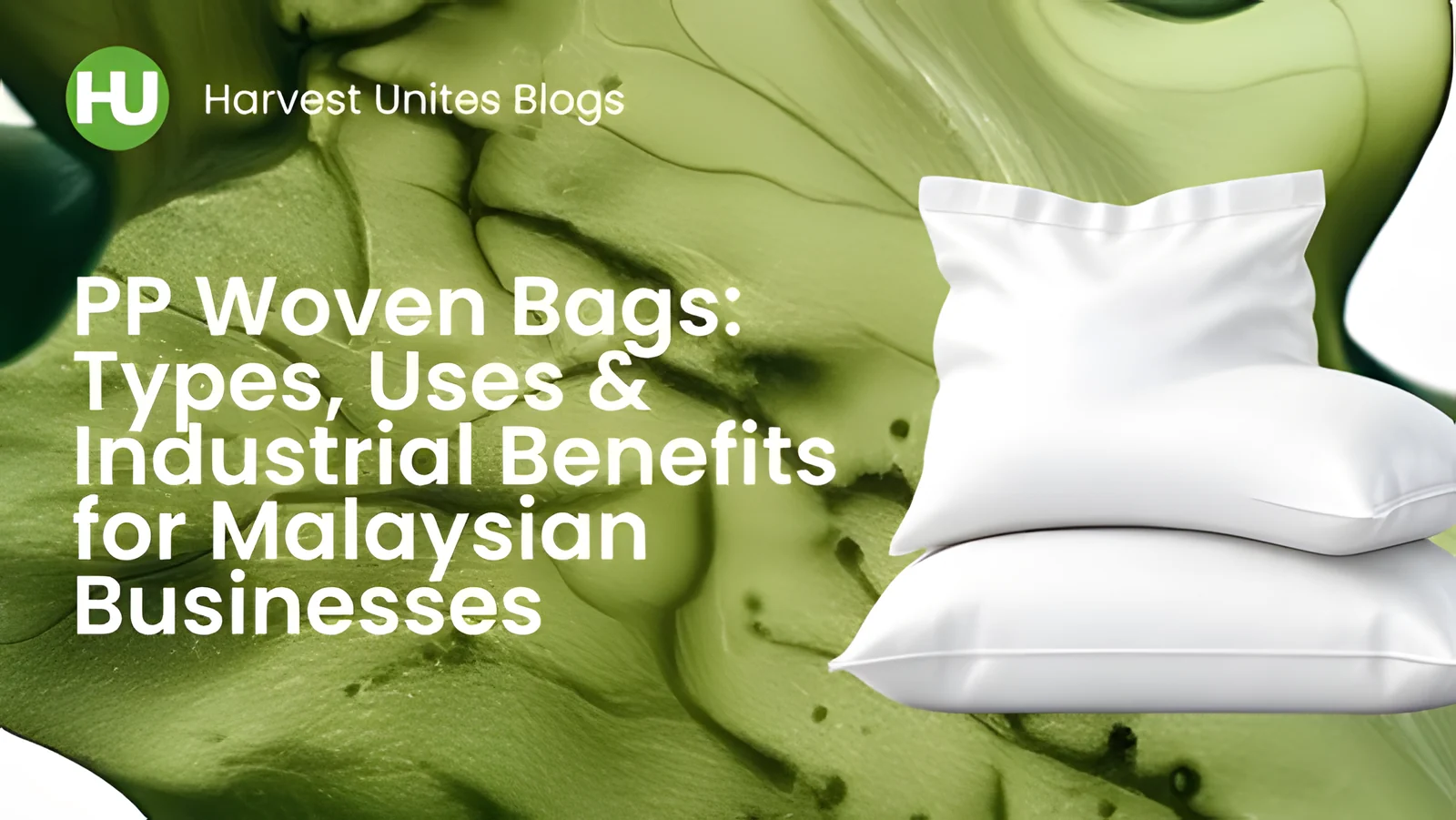 Stacked white PP woven bags on a green textured background for industrial packaging in Malaysia