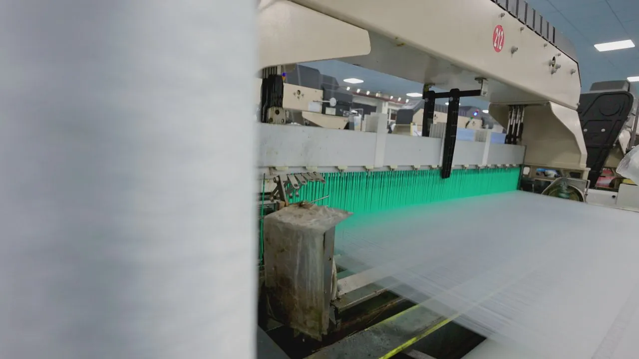 Industrial loom weaving white woven fabric used for sacks